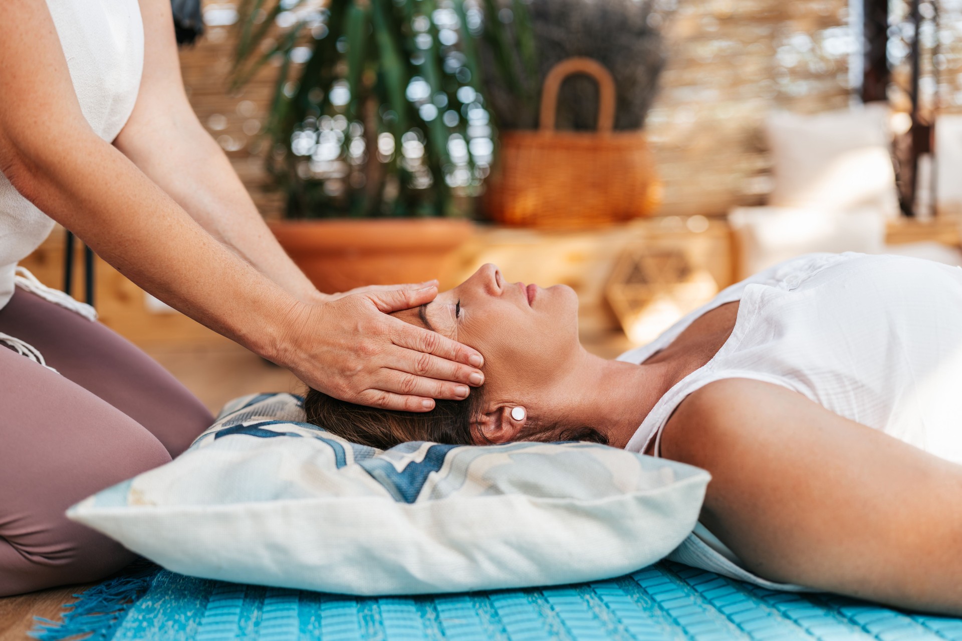 Reiki master heals with energy body of her client